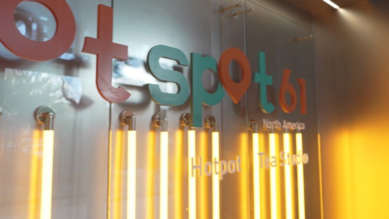 The Hot Spot 61 logo wall with glowing yellow lights