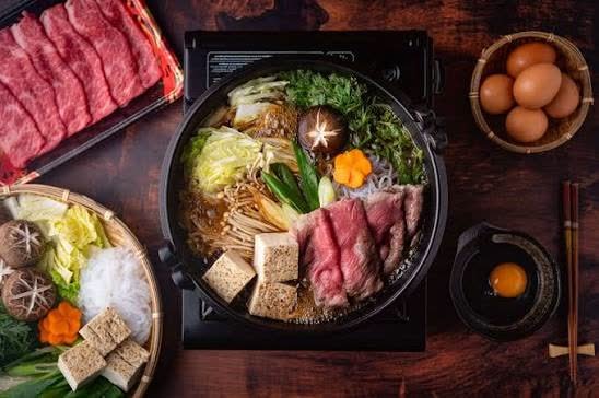 Sukiyaki with sliced beef, tofu, mushrooms and napa cabbage
