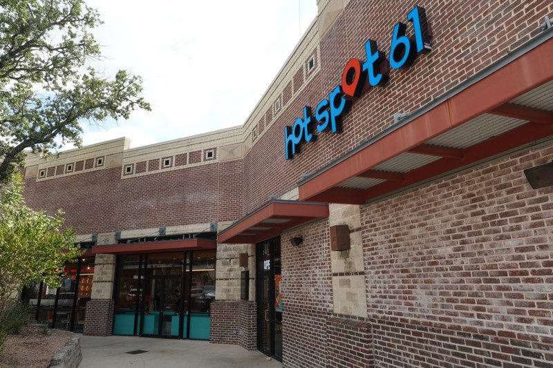 The Hot Spot 61 storefront at Huebner Oaks with the blue Hot Spot 61 sign